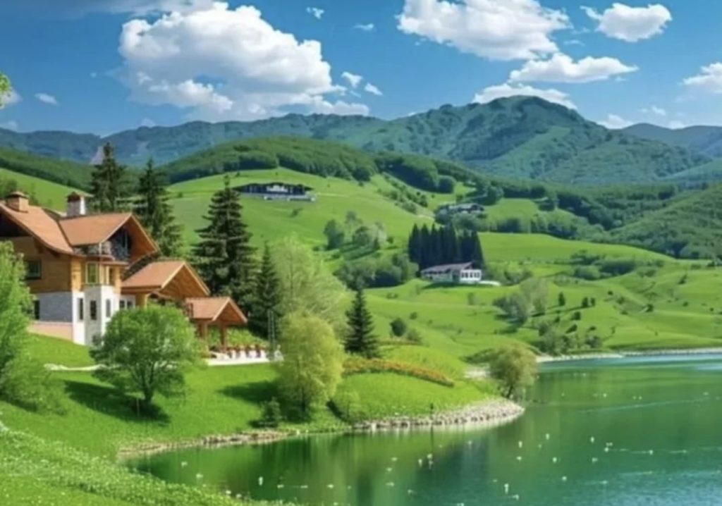 Sunlit lakeside promenade with colourful loungers beside calm blue water and hillside villages